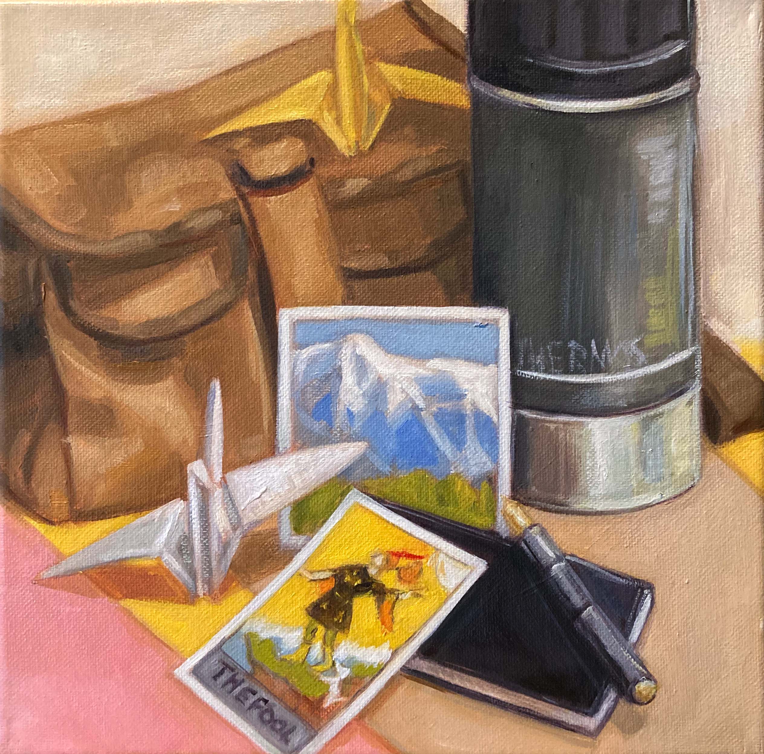 Still life painting of a brown bag, photo of montains, white paper crane, thermos, fountain pen, note book and The Fool tarot card.