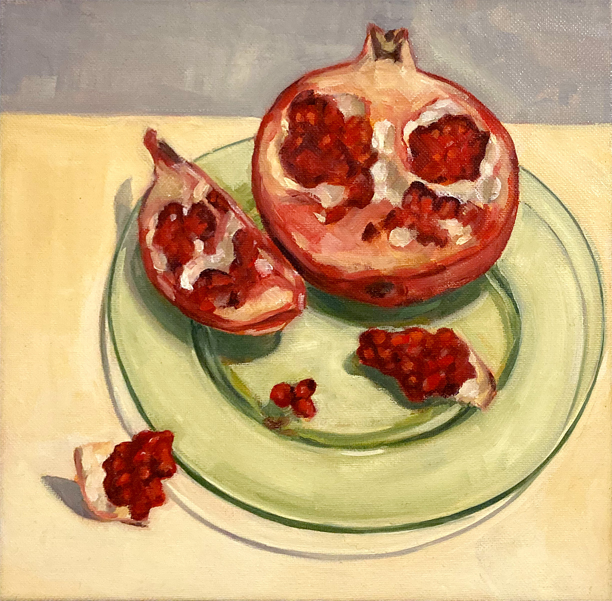 Painting of pomegranate slices on a green glass plate.